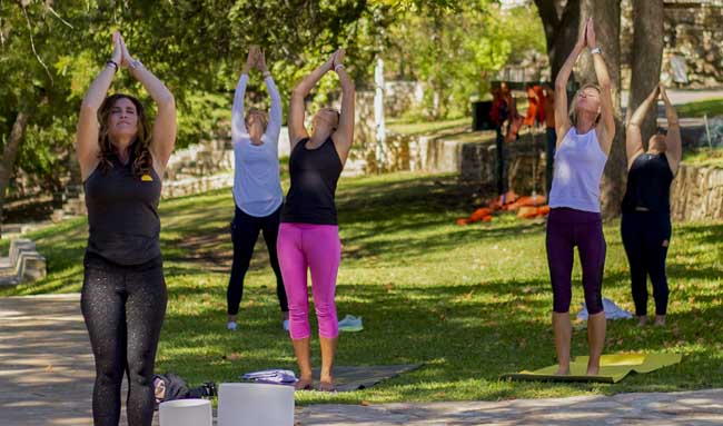 Ladies practicing yoga outdoors